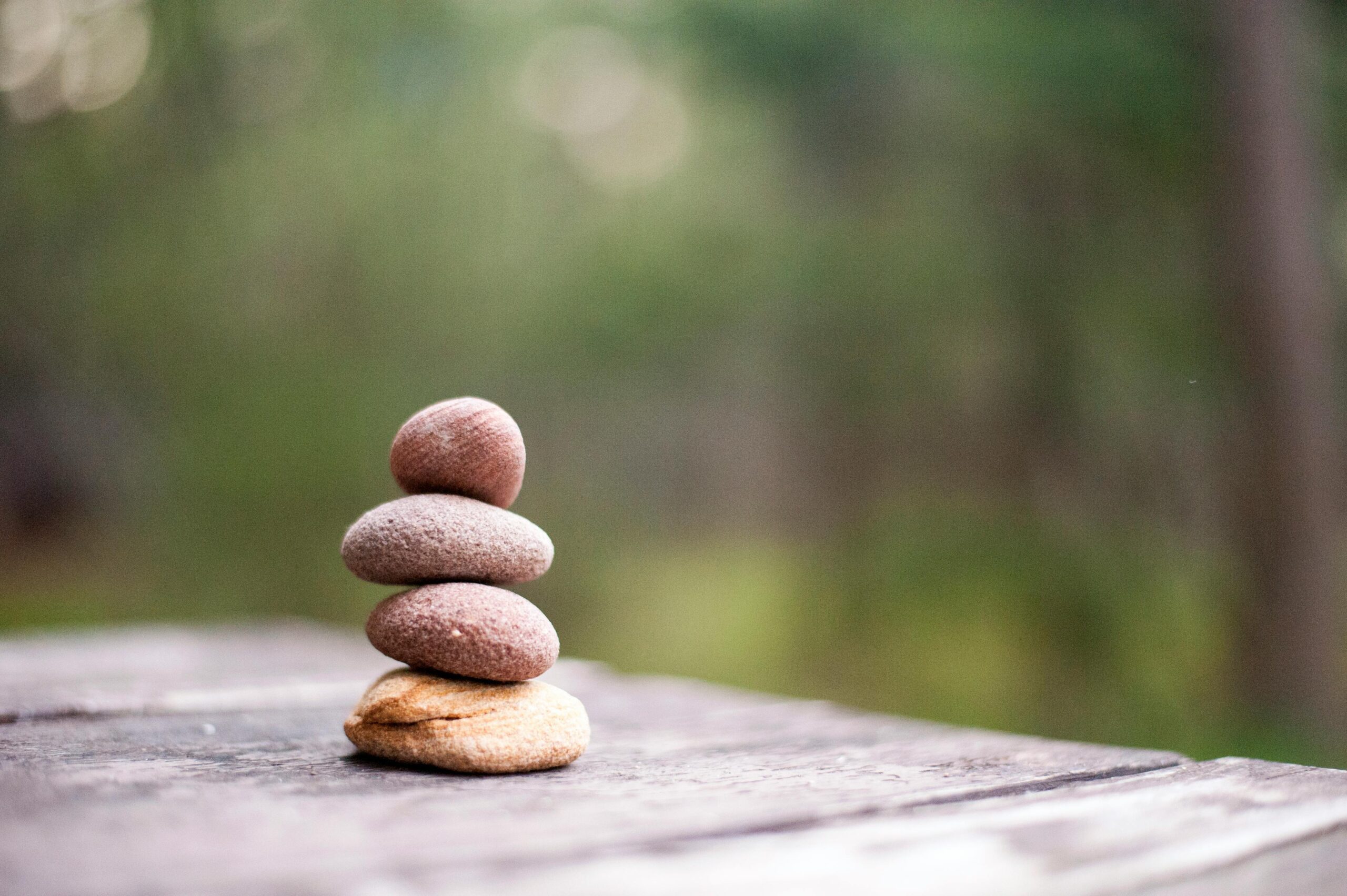 Balance and tranquility embodied by stacked stones in a natural outdoor setting.