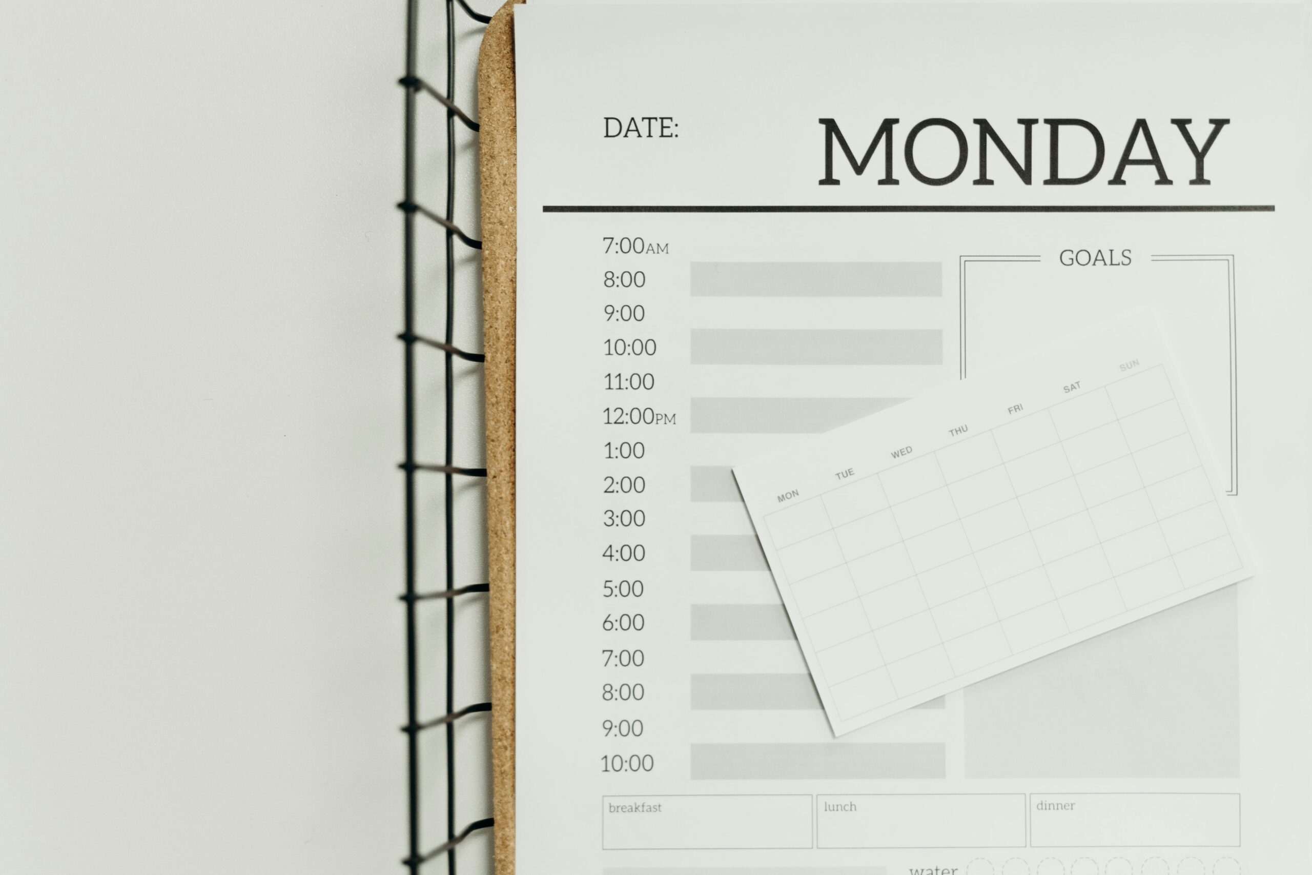 Top view of a minimalist schedule planner with Monday header. Perfect for organizing daily tasks with goals section.