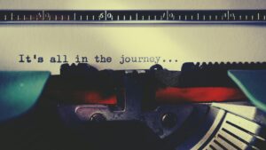 Close-up of a vintage typewriter typing an inspirational quote about the journey.