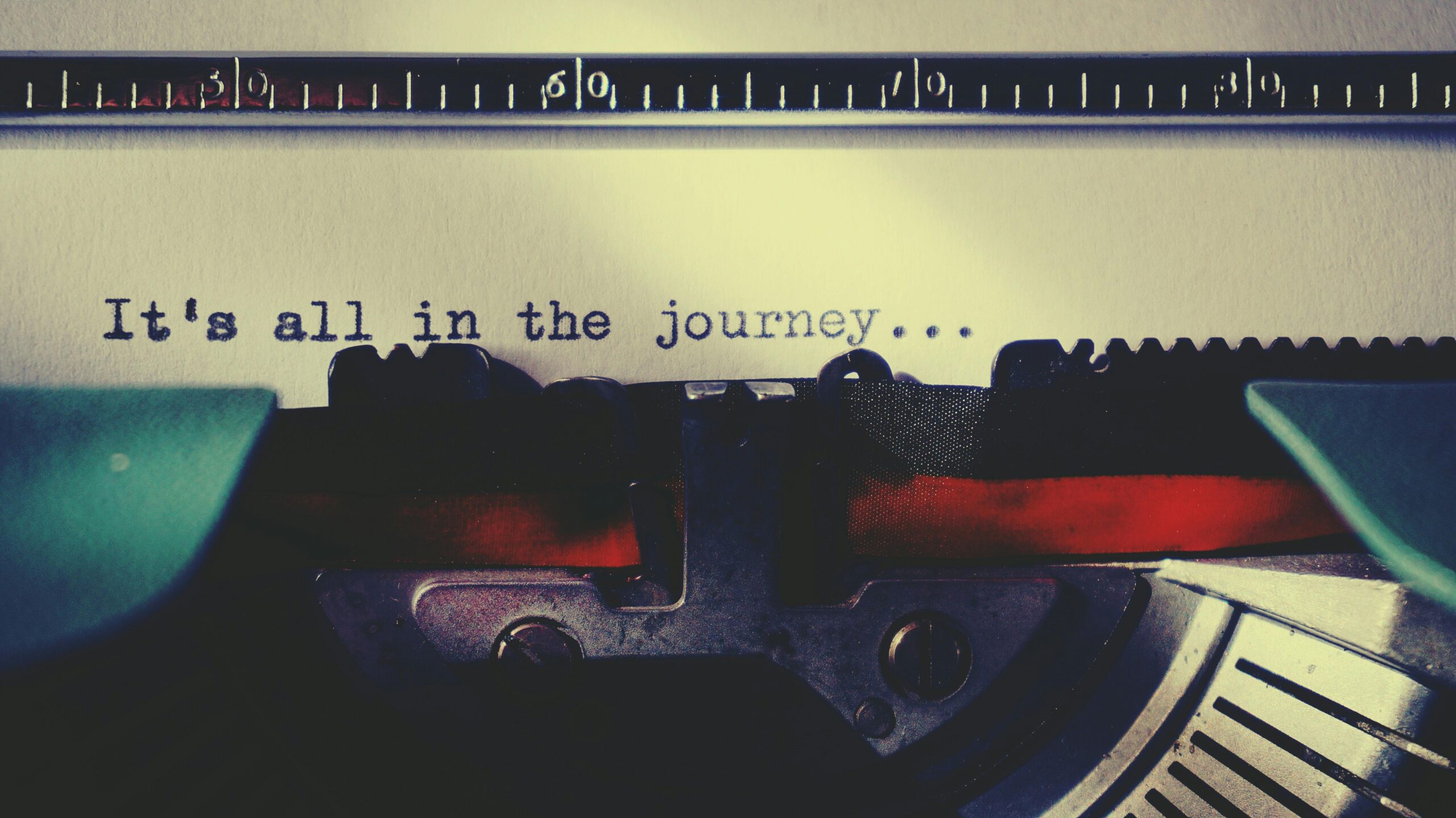 Close-up of a vintage typewriter typing an inspirational quote about the journey.