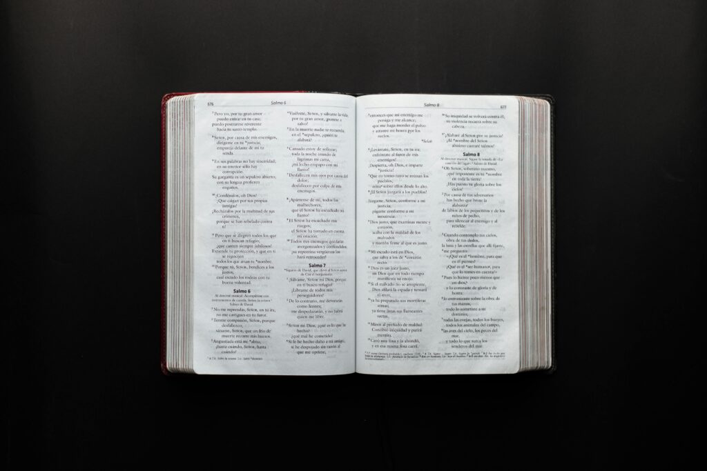 Open Bible displaying Psalms on a dark surface for study or inspiration.