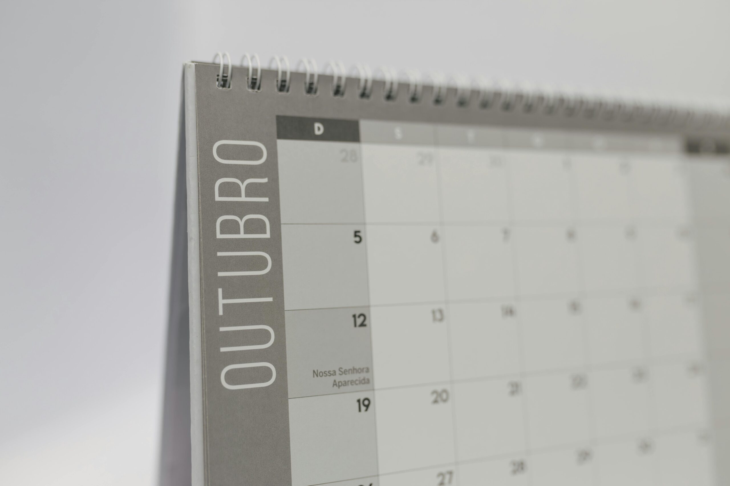 Close-up of October's page on a standing desk calendar with smooth minimalist design.